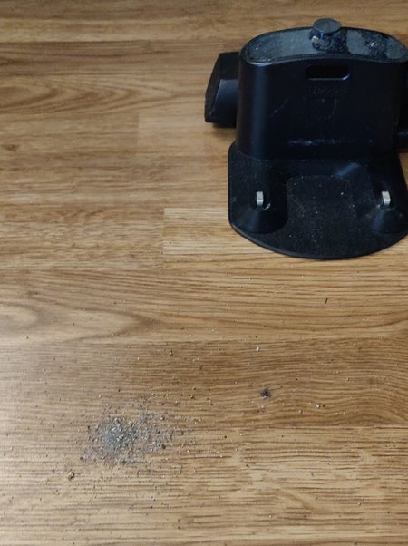 dirt on the floor, next to the charging station