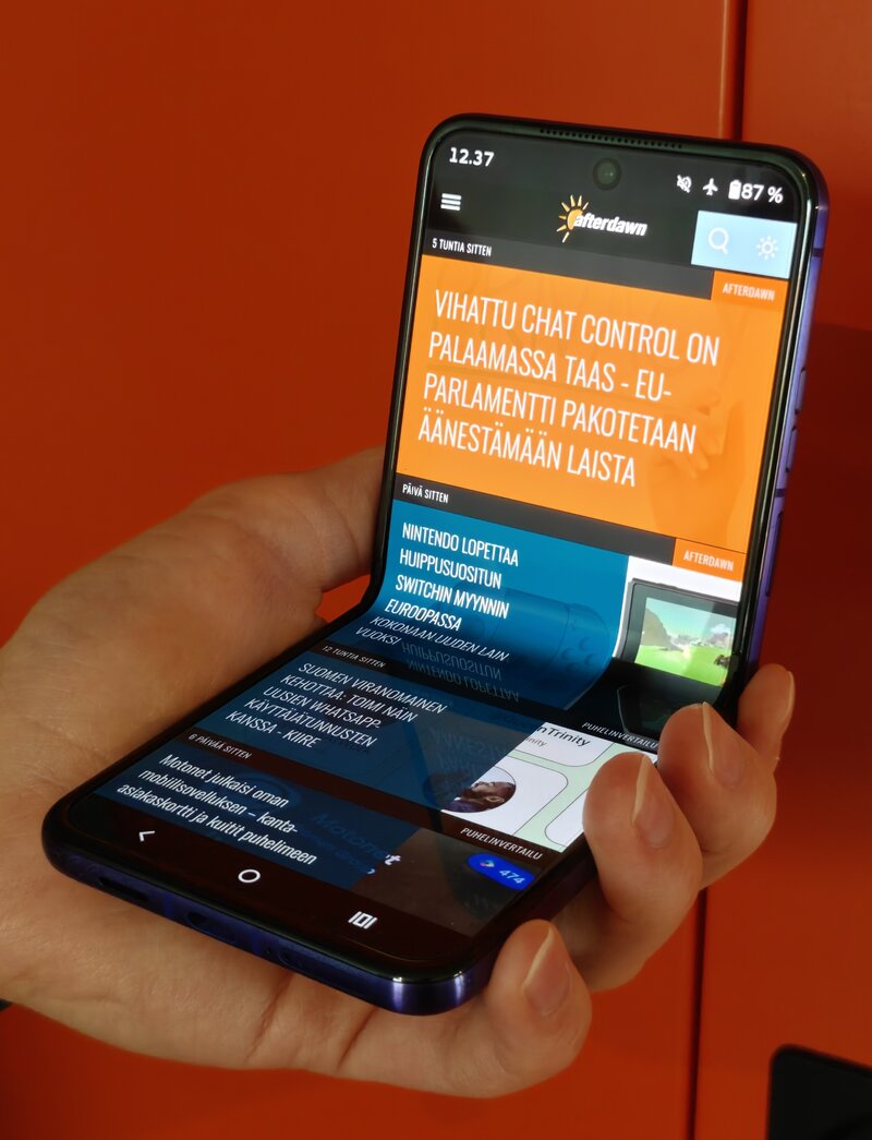 Motorola Razr 70 Ultra, kädessä, päänäytöllä verkkosivusto auki